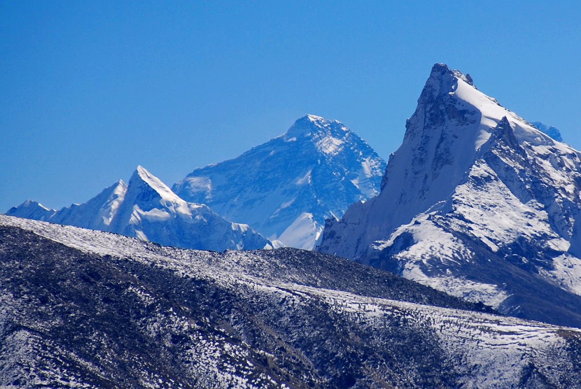 07 Mount Everest From Trek Between Shingdip And Shishapangma Southwest Advanced Base Camp As I continued my trek between Shingdip and Shishapangma Advanced Base Camp, I looked back to get a distant view of Mount Everest. I think the peak on the left is Nangpai Gosum I (7351m, also called Pasang Lhamu Chuli, Josamba and Cho Aui), on a long ice ridge connecting to Cho Oyu.